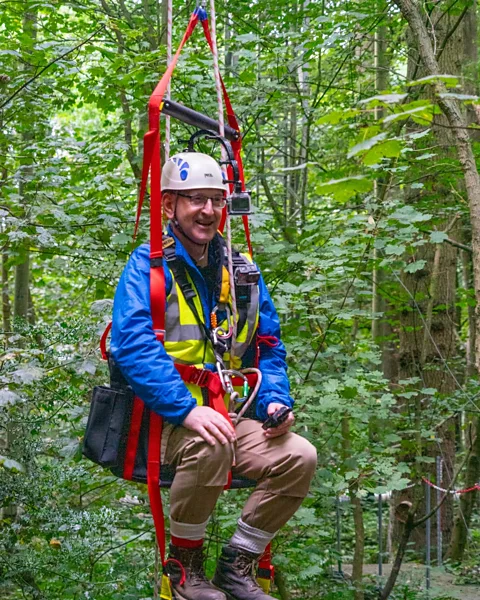 Thomas Downes Researcher Rob MacKenzie prepares to journey to the forest canopy (Credit: Thomas Downes)